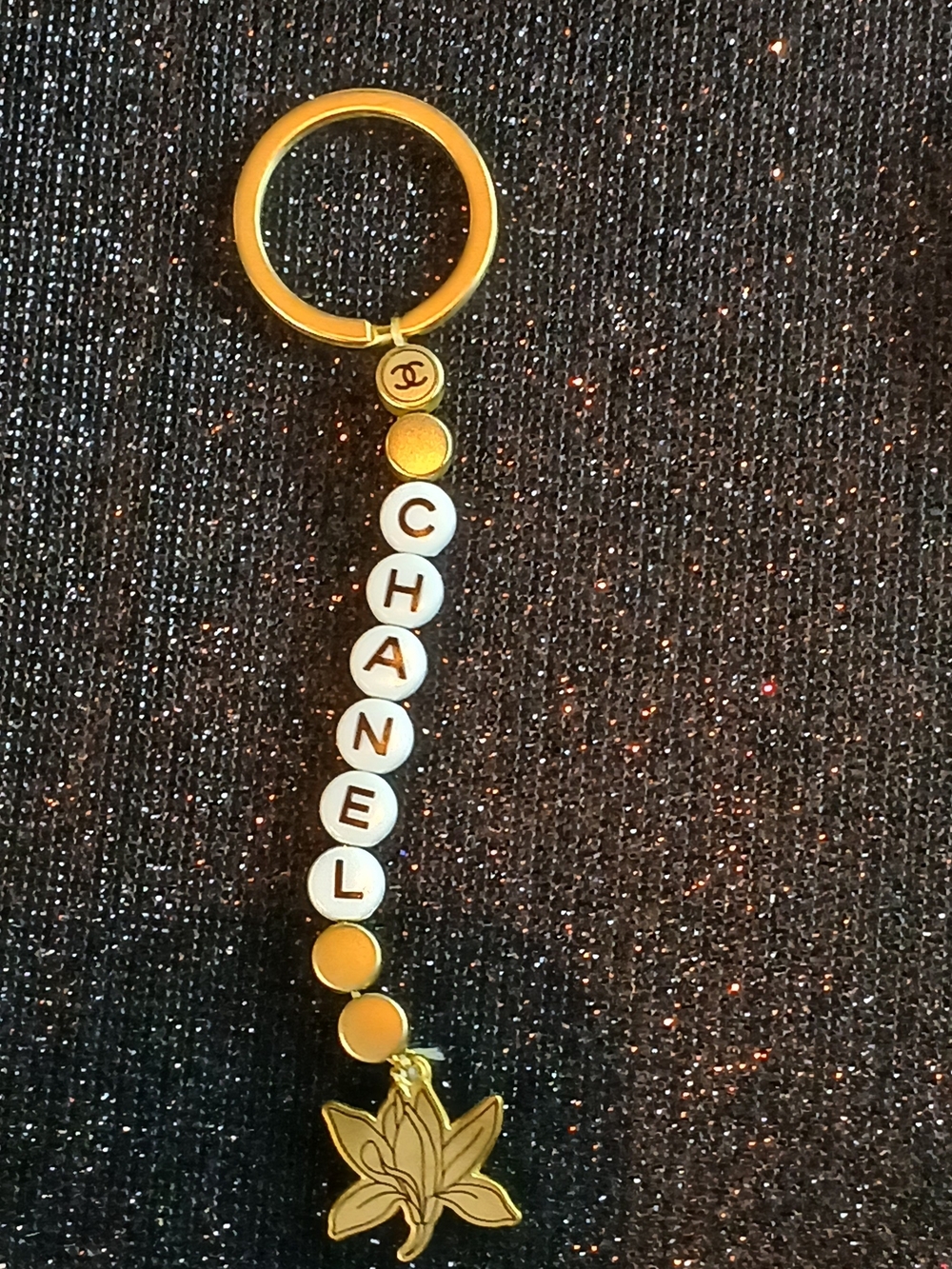CHANEL Gold-tone and White Beaded Key Holder with Floral Charm